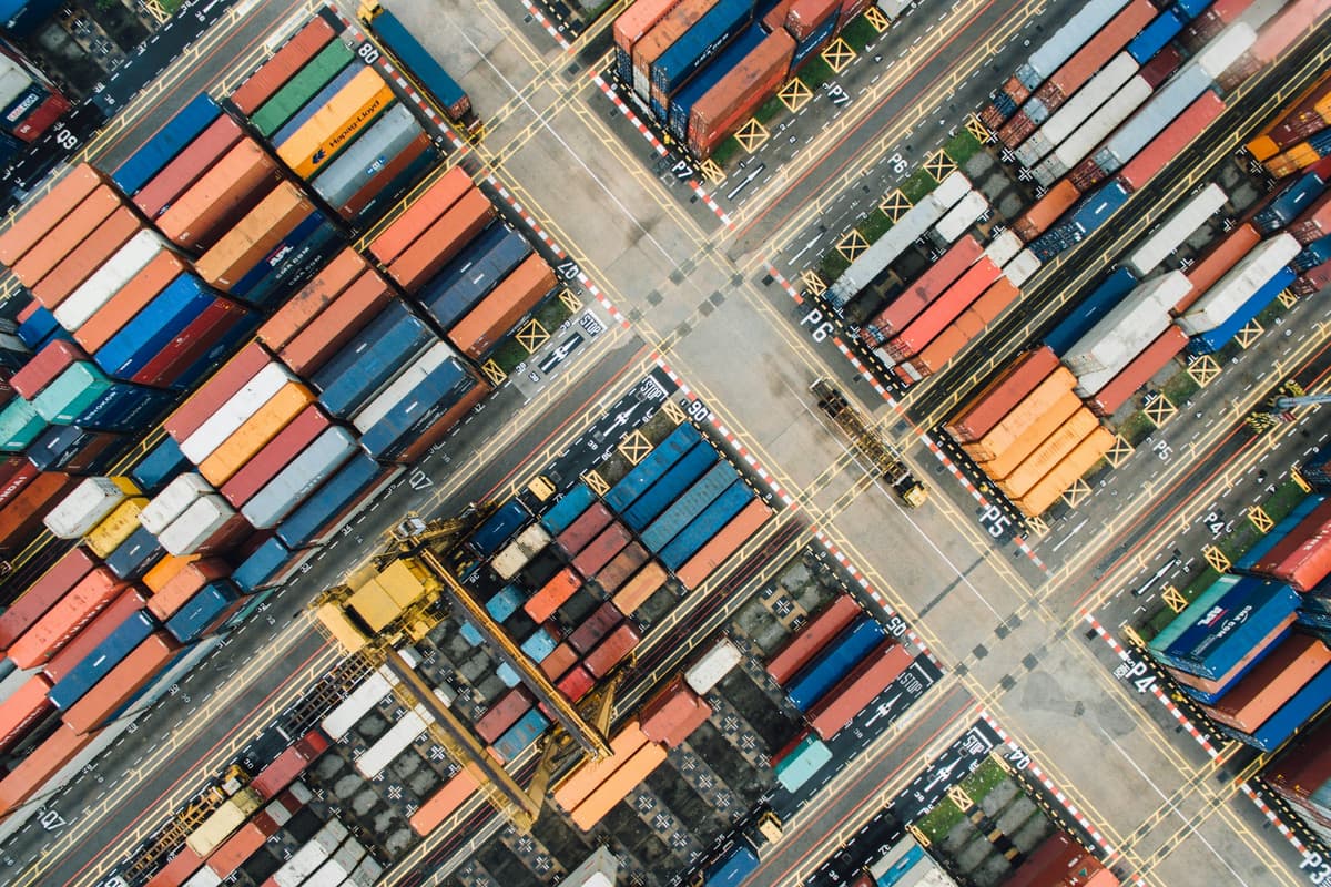 Aerial view of a container yard with rows of colorful shipping containers